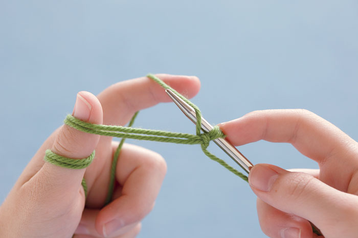 Reach the needle behind the single strand of yarn, as if making a yarnover.